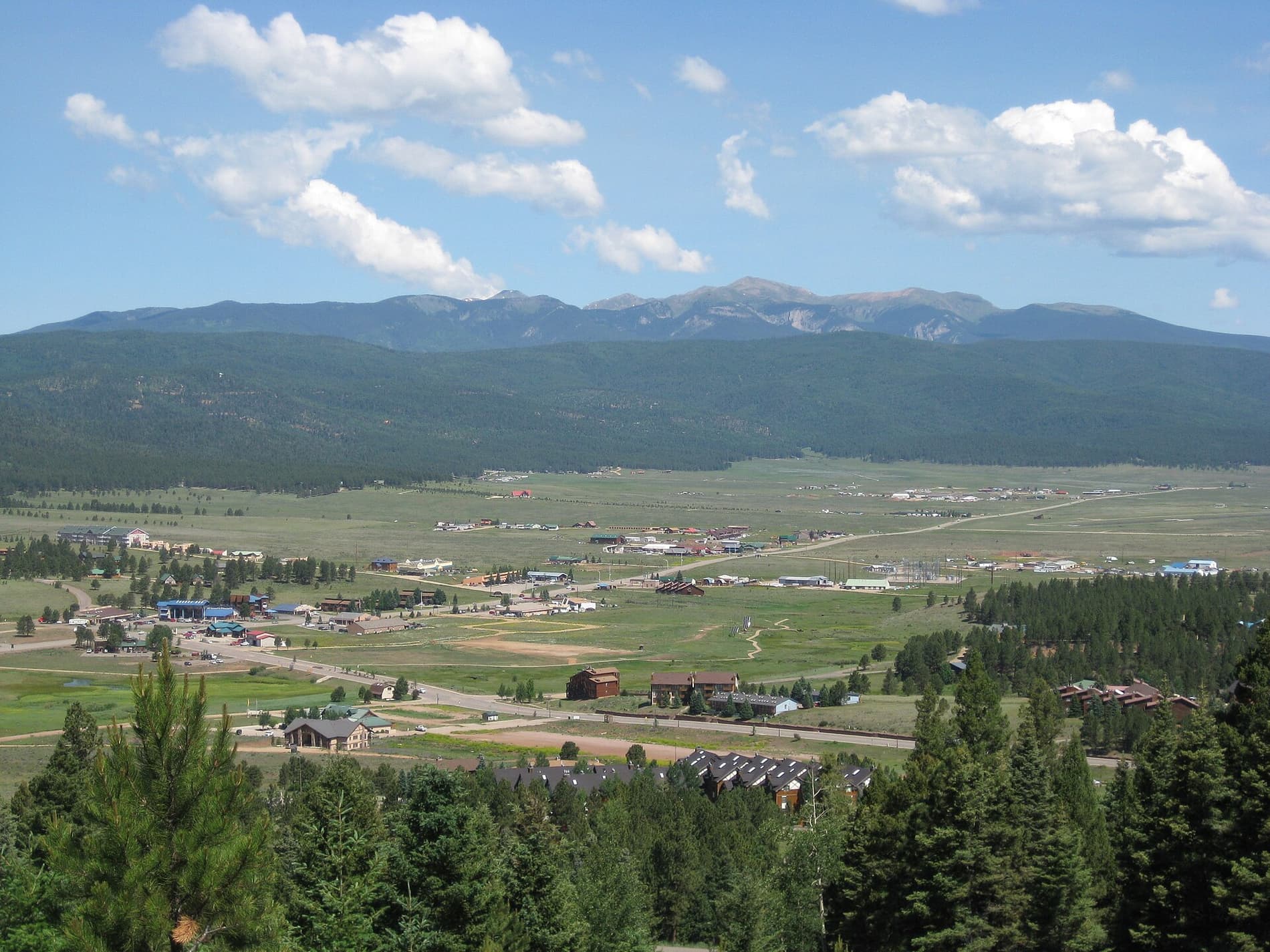 Summer view over the Moreno Valley and the village of Angel Fire, with the Sangre de Cristo mountains behind
